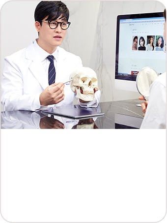 Surgeon explaining facial anatomy and follow-up care to a patient